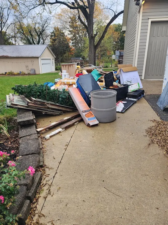 Dumpster being loaded with debris for 12 Yard Dumpster Rental in Virginia Beach